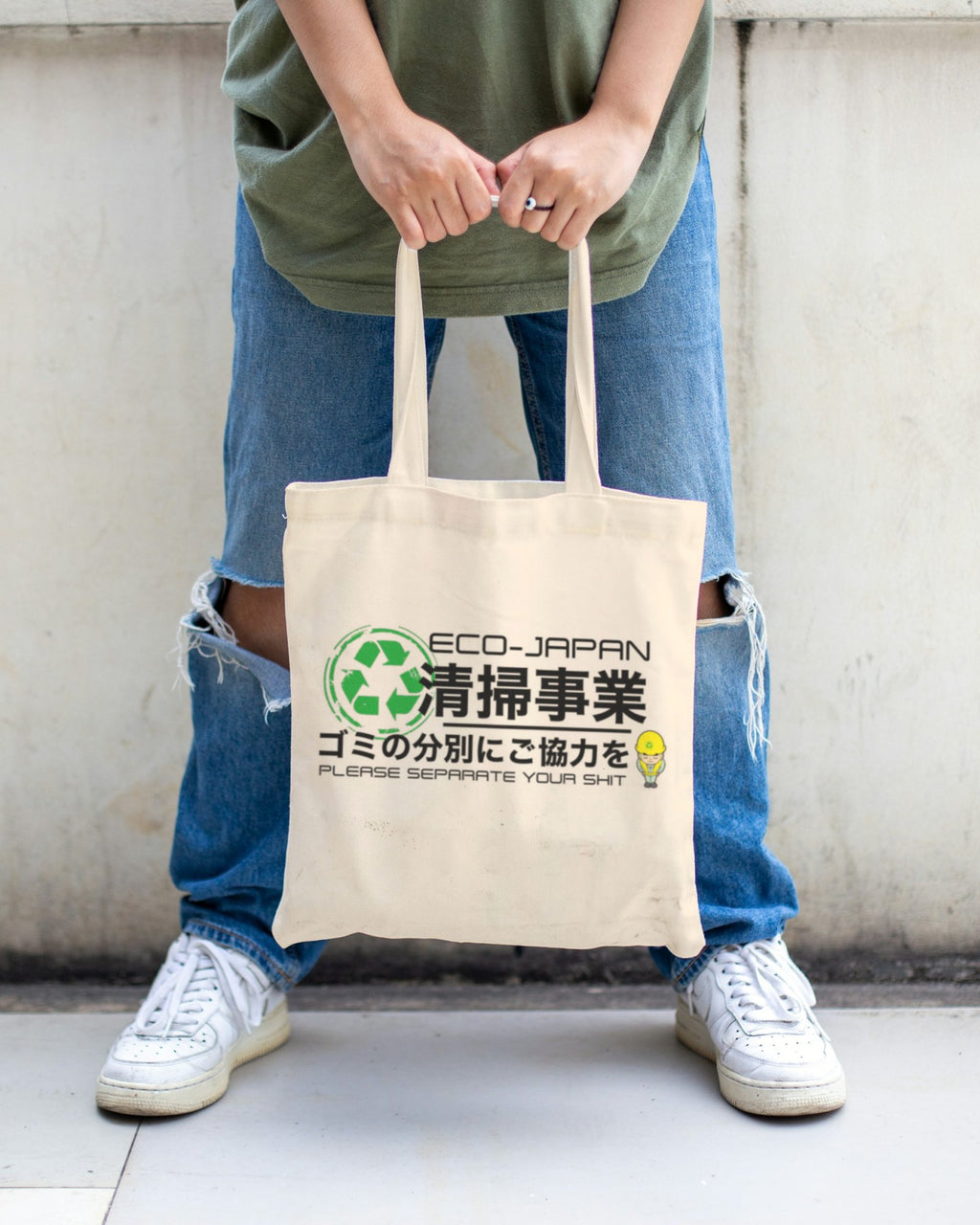 Japanese Recycling natural canvas tote bag by Spice Tokyo carried in front of a concrete wall