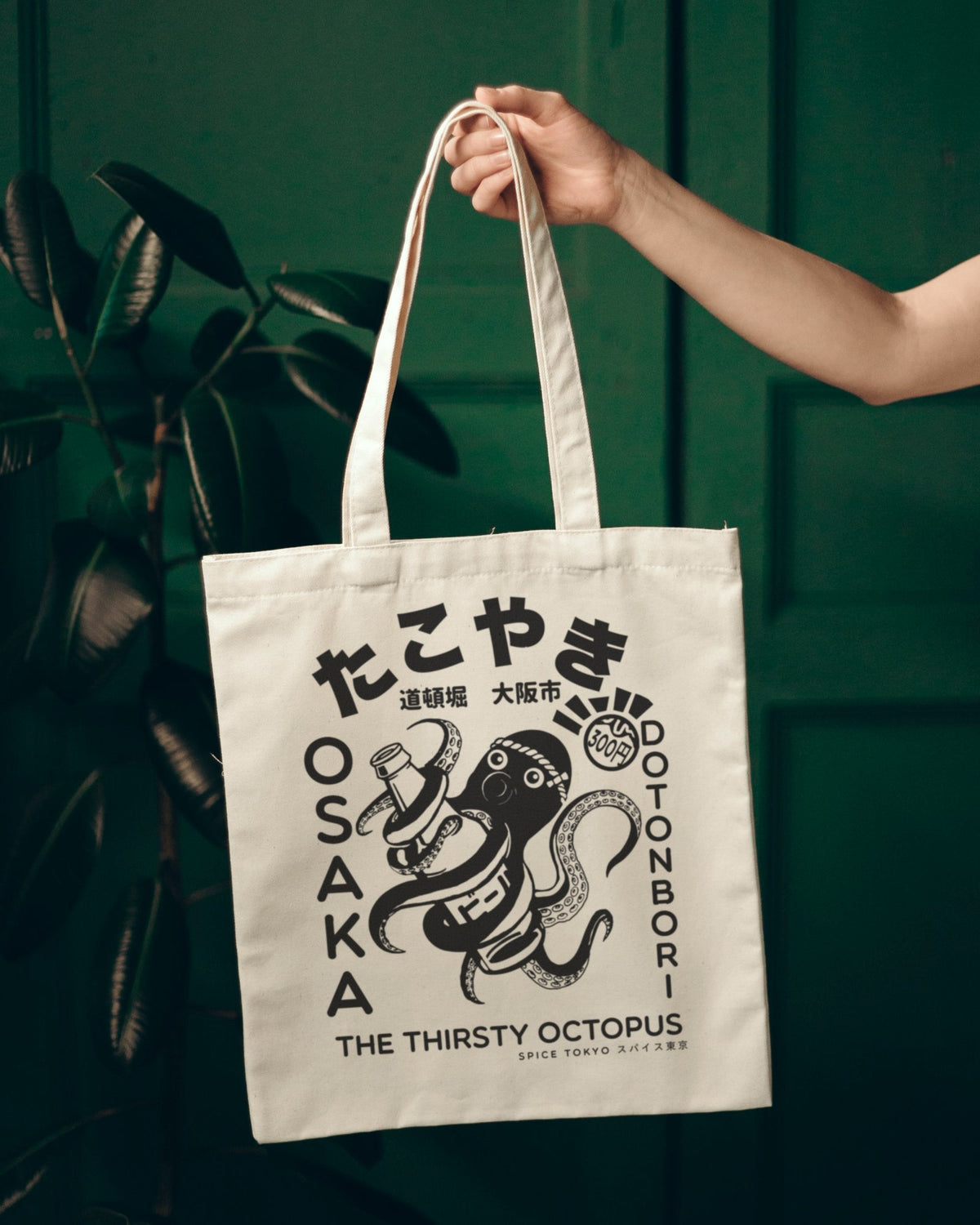 Takoyaki Thirsty Octopus natural canvas tote bag by Spice Tokyo held by its handles