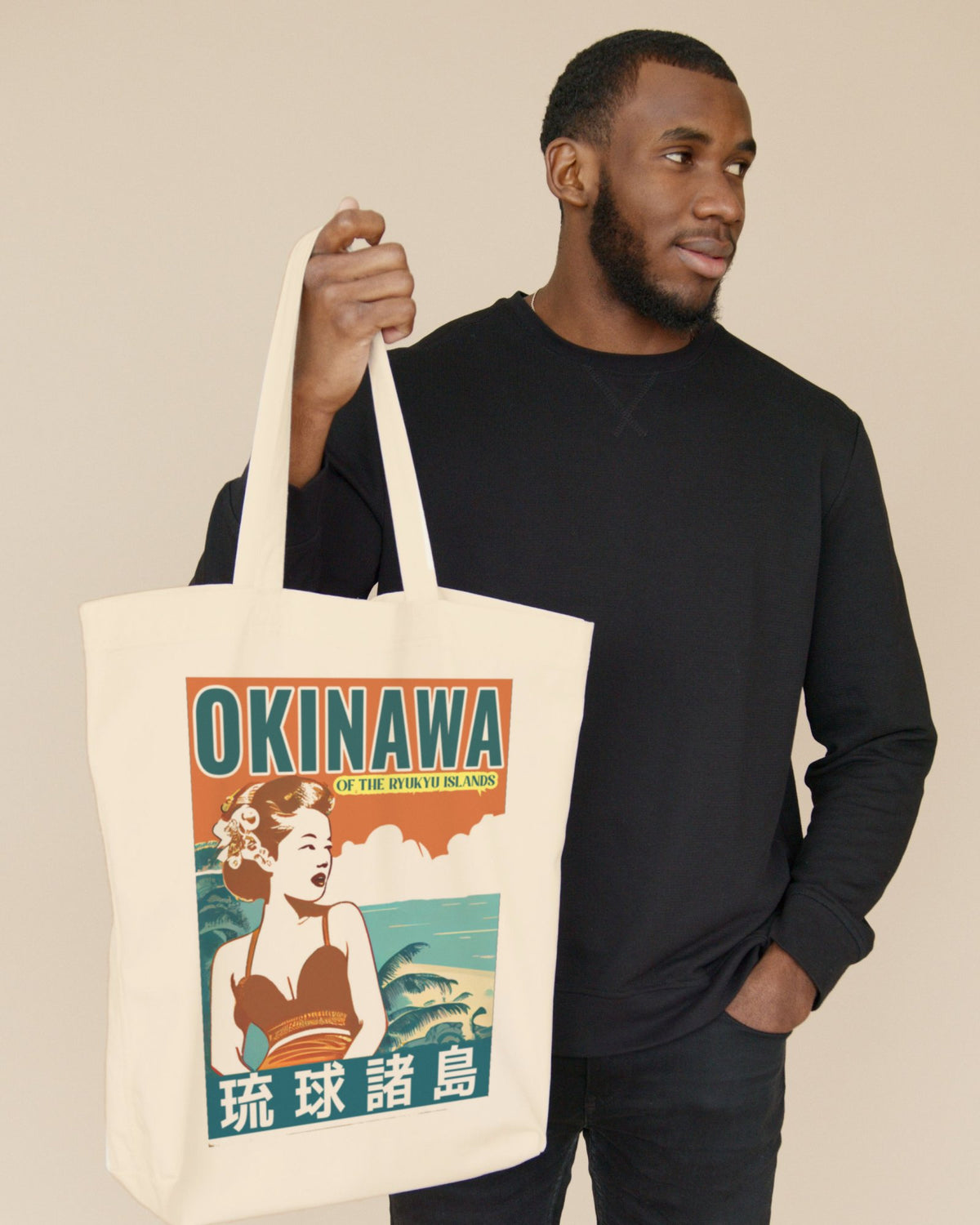 Man carrying the Visit Okinawa Retro natural canvas tote bag by Spice Tokyo